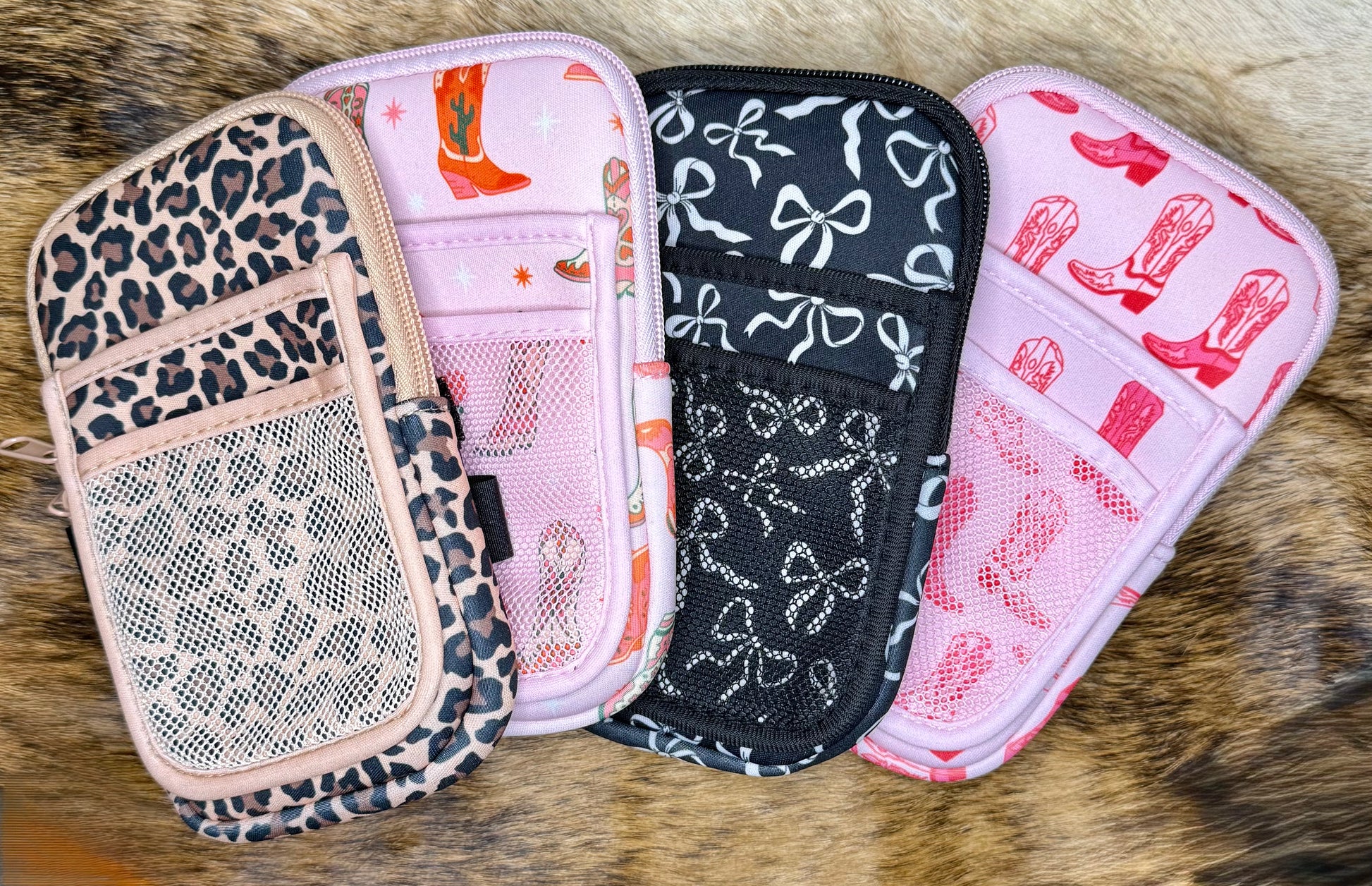 Four patterned pouches on a fur surface
