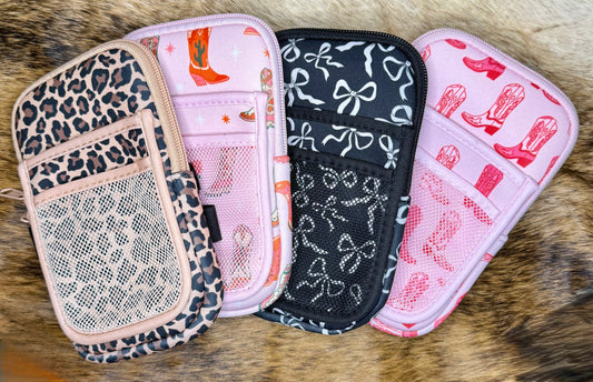 Four patterned pouches on a fur surface
